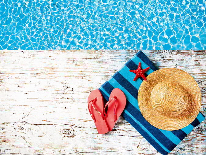 Concept,Of,Summer,Accessories,On,Wood,With,Blue,Water,As